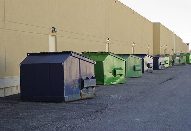 big yellow dumpsters on a construction lot in Iron River, WI